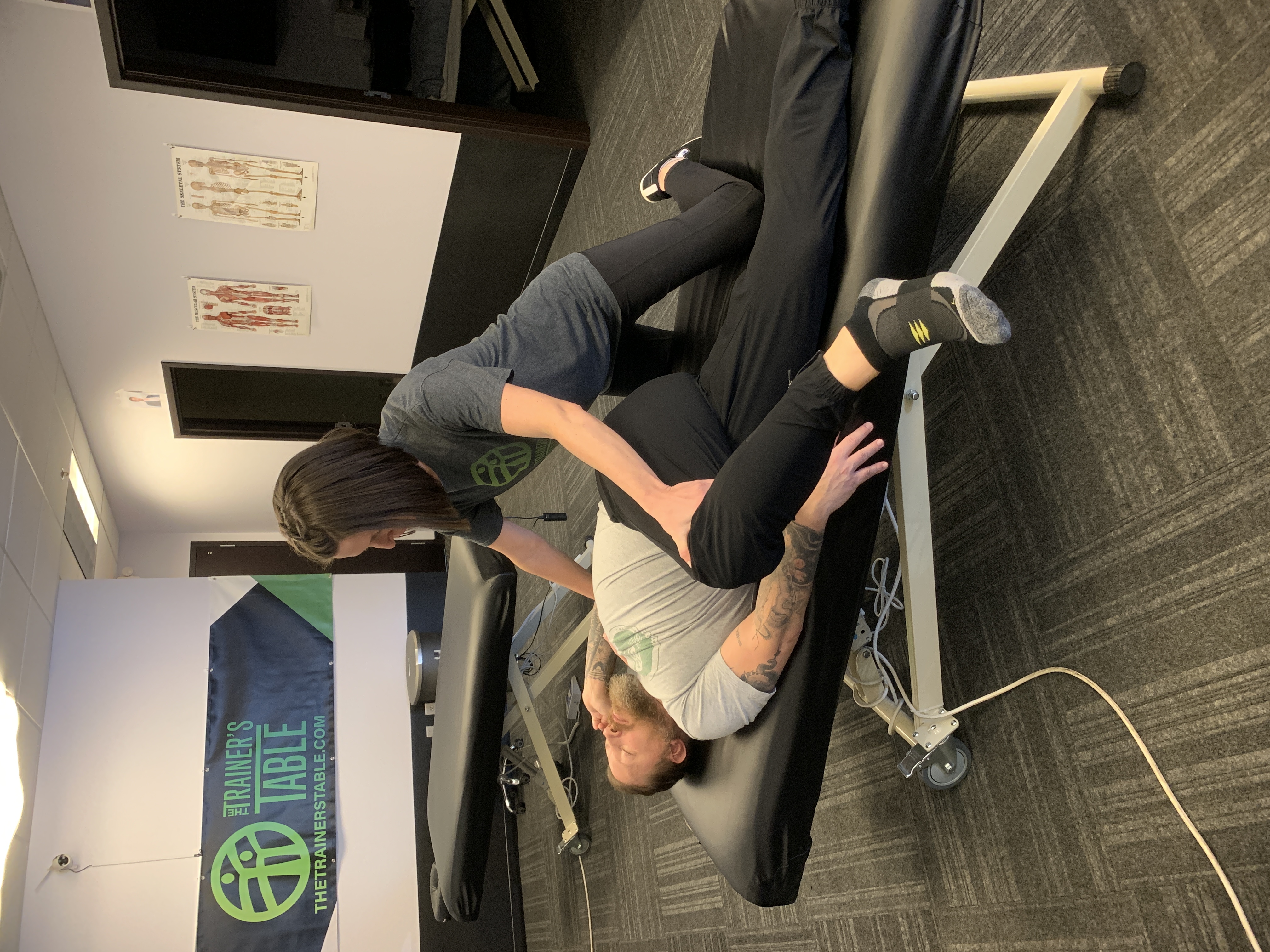 A therapist performing an assisted hip stretch