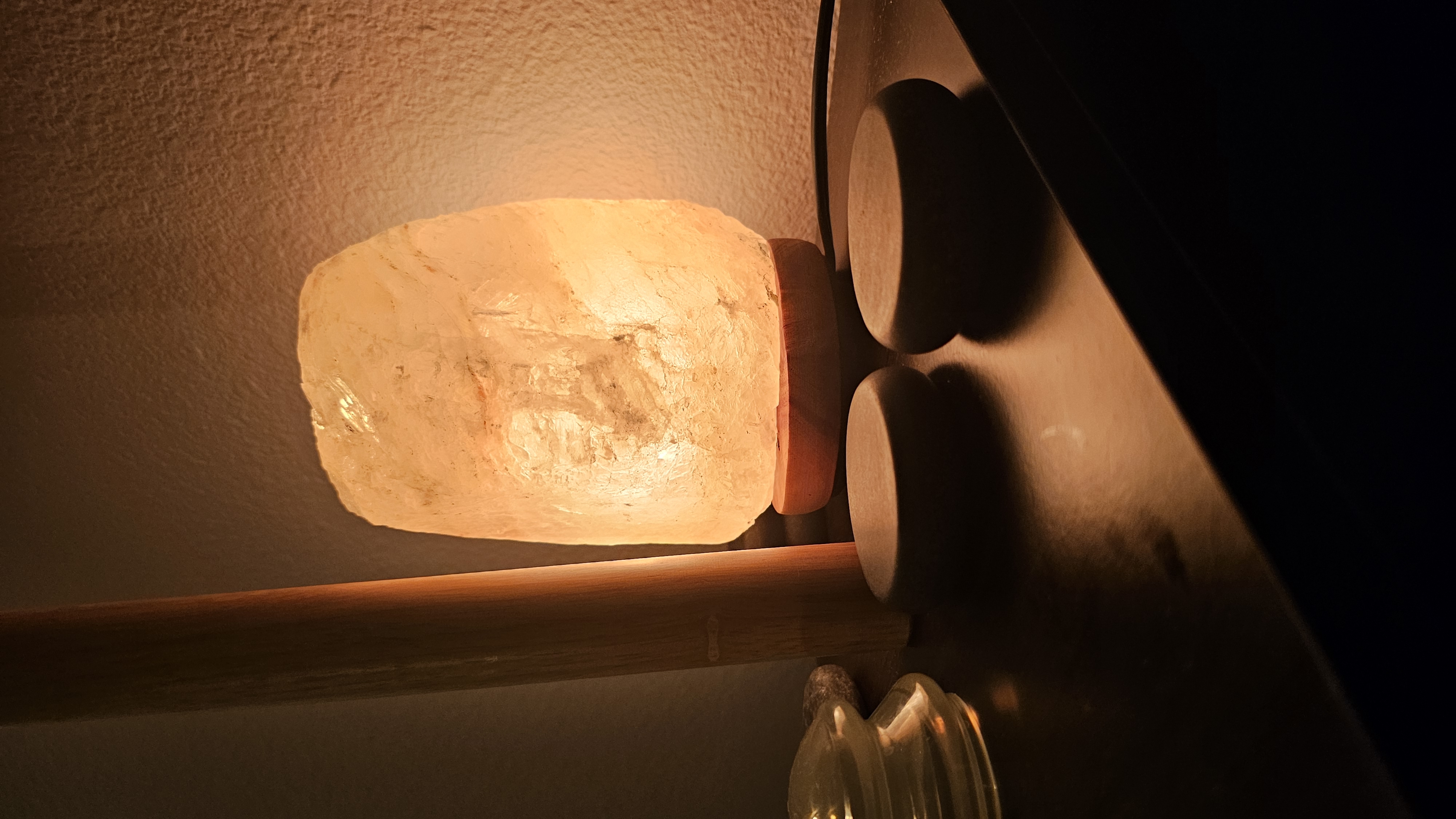 Warm massage-room details with hot stones and a salt lamp